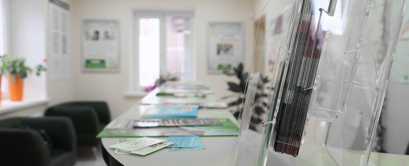 A lobby desk with business cards, brochures, and other collateral on top of it.